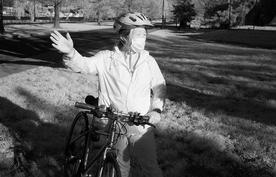 Infrared Portrait of Masked Woman With Her Bicycle.
